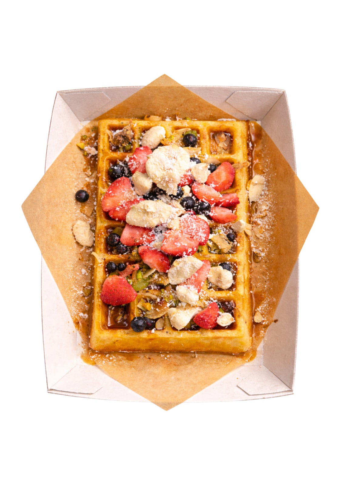 Signature waffle topped with strawberries, blueberries, coconut and halva